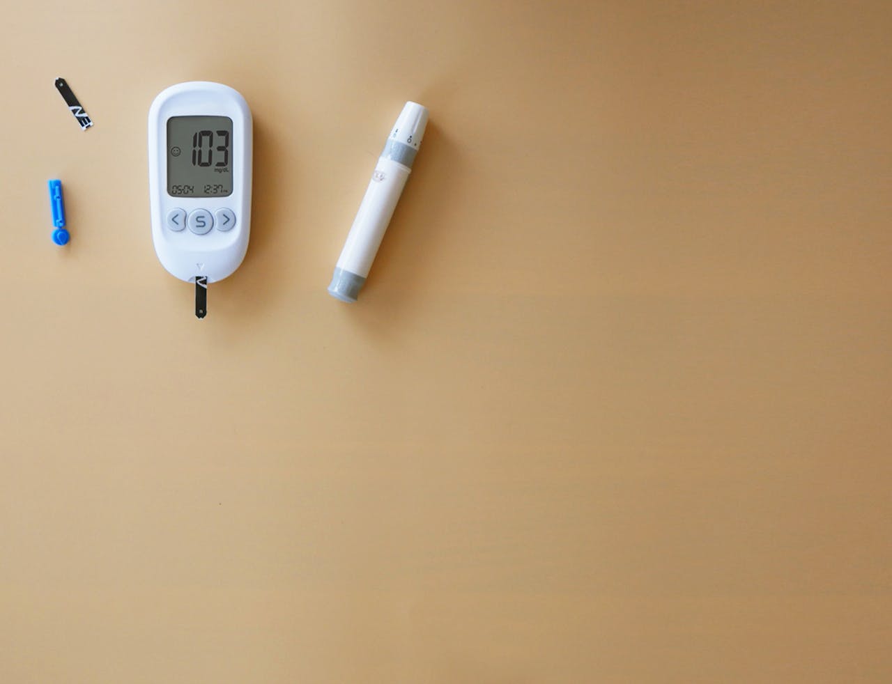 about-us-01 Blood glucose meter and lancet pen on wood for diabetes monitoring