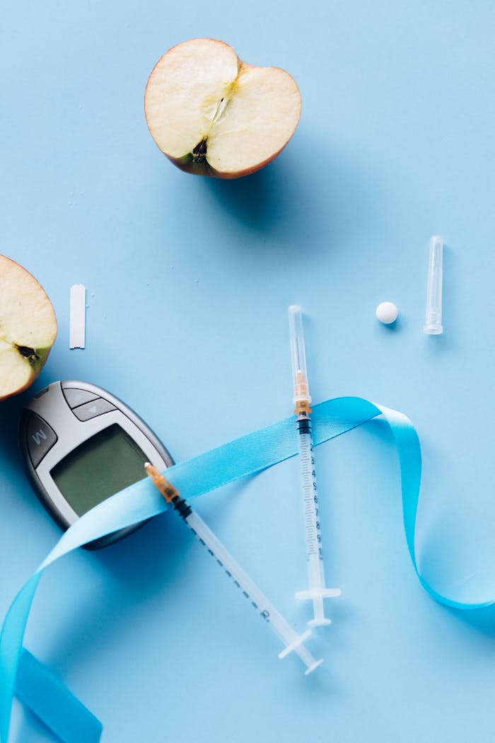 services-03 Flat lay of diabetes tools with sliced apple on blue background.