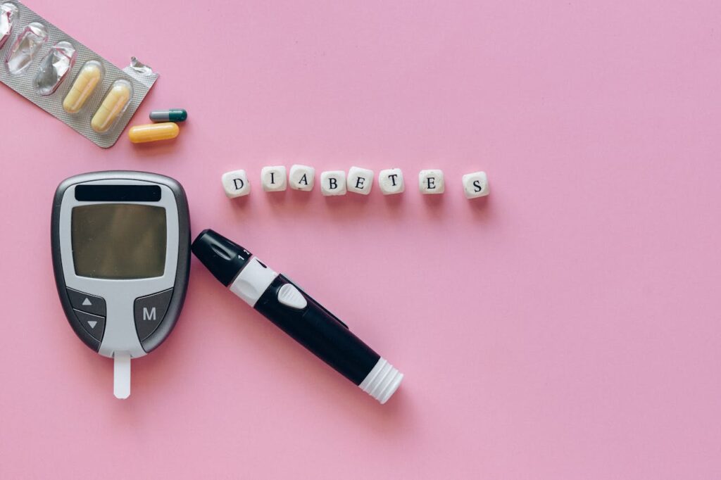 Mastering the First Impression: Your intriguing post title goes here Close-up of diabetes management tools including glucometer and pills on a pink background.